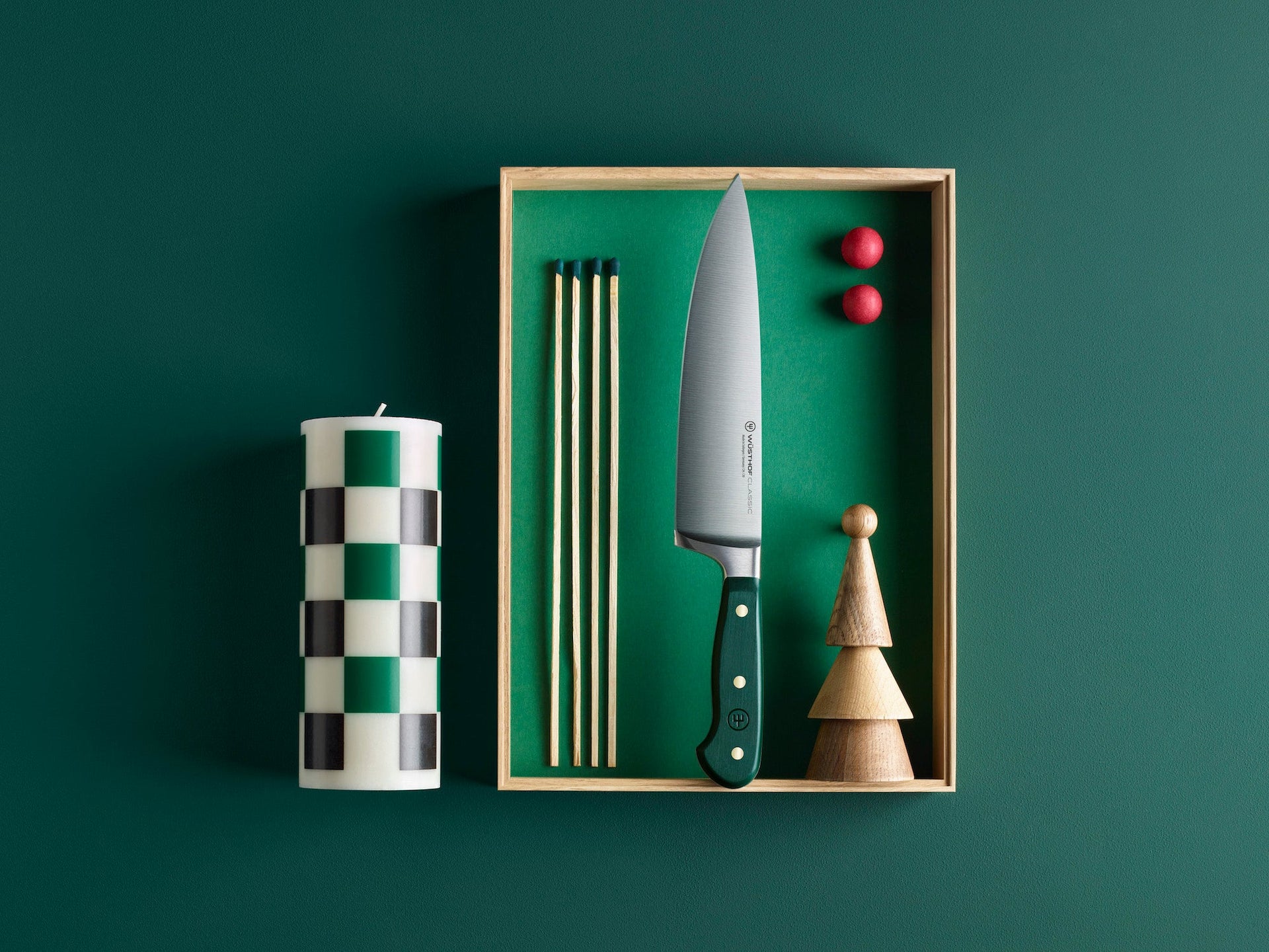 Knife with green handle in a box on a dark green background