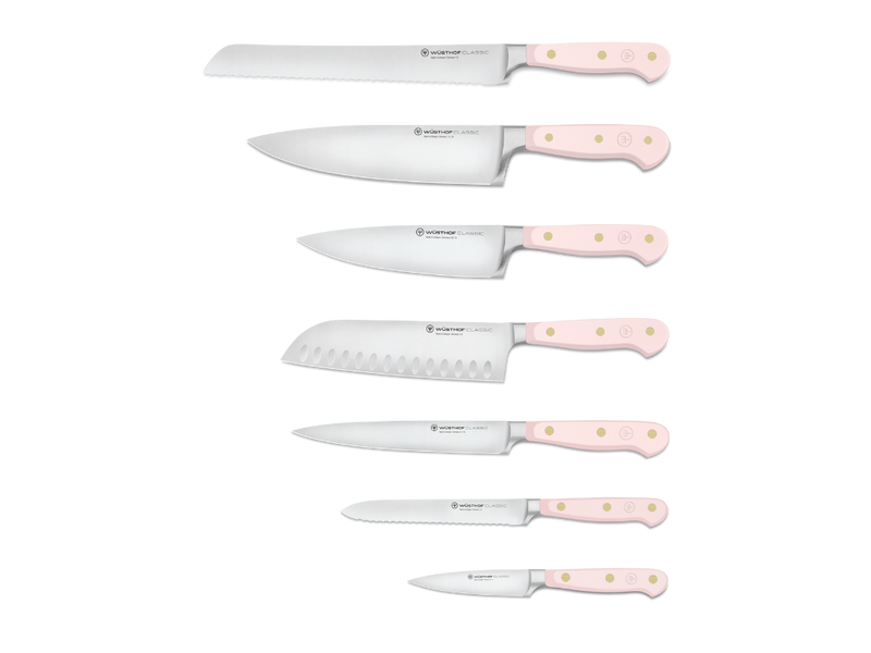Six kitchen knives with pale pink handles featuring three brass rivets each and polished stainless steel blades for versatile culinary tasks.
