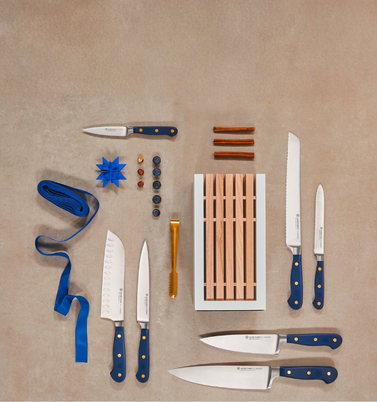Knives on table with holiday decorations around them.