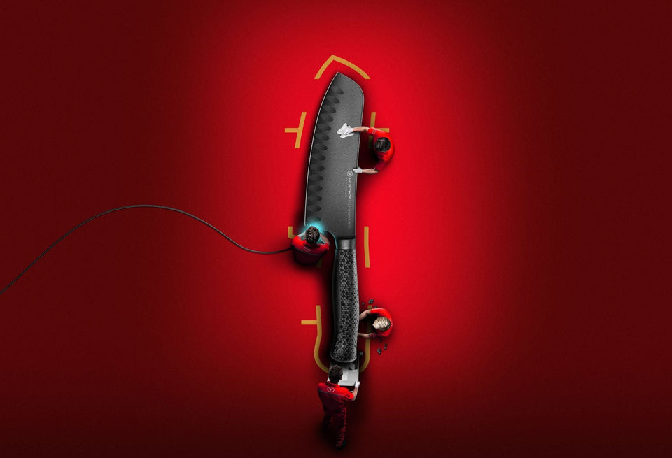 Black knife with red and yellow accents on a red background