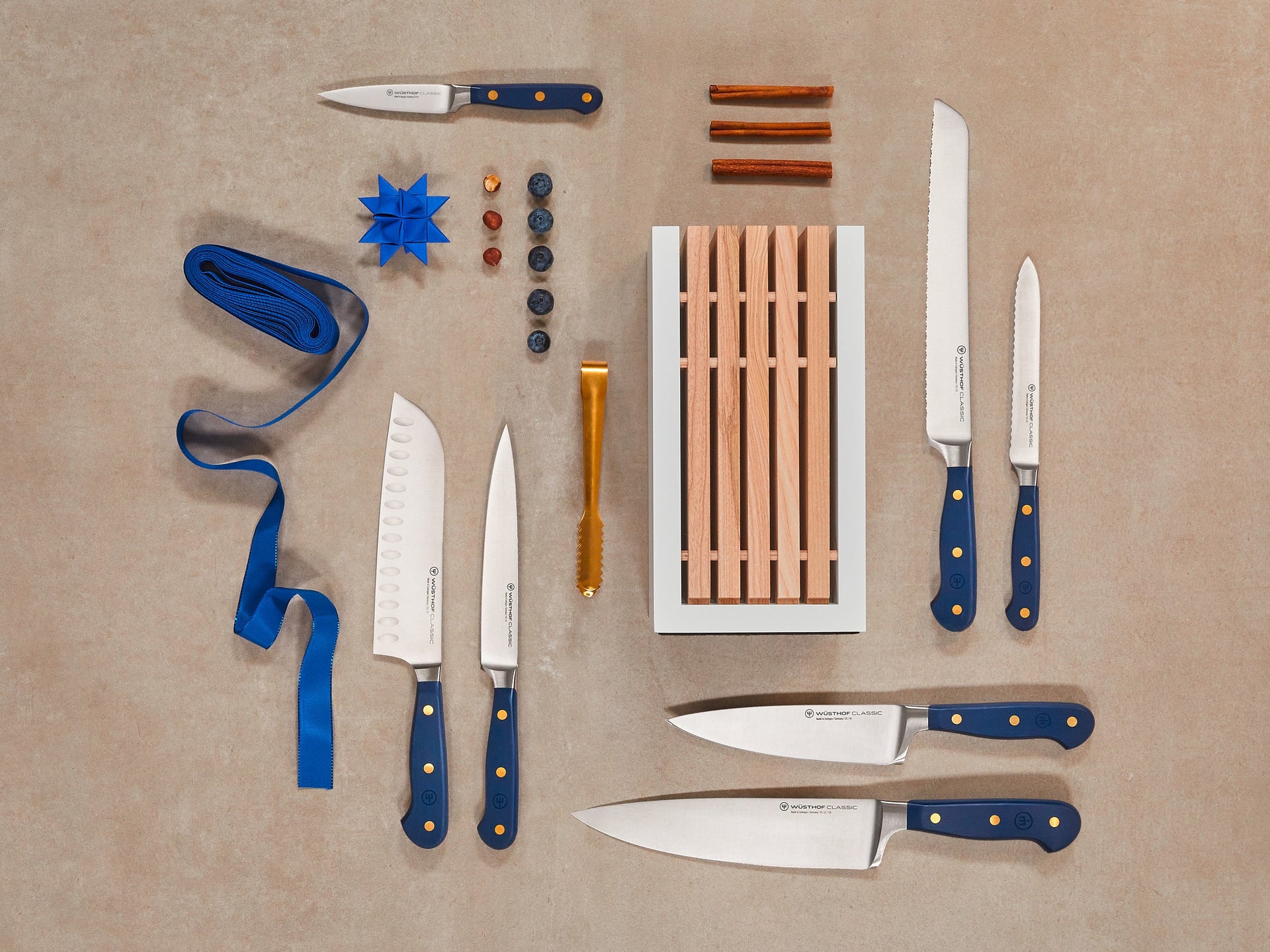 Collection of knives with blue handles on a beige background